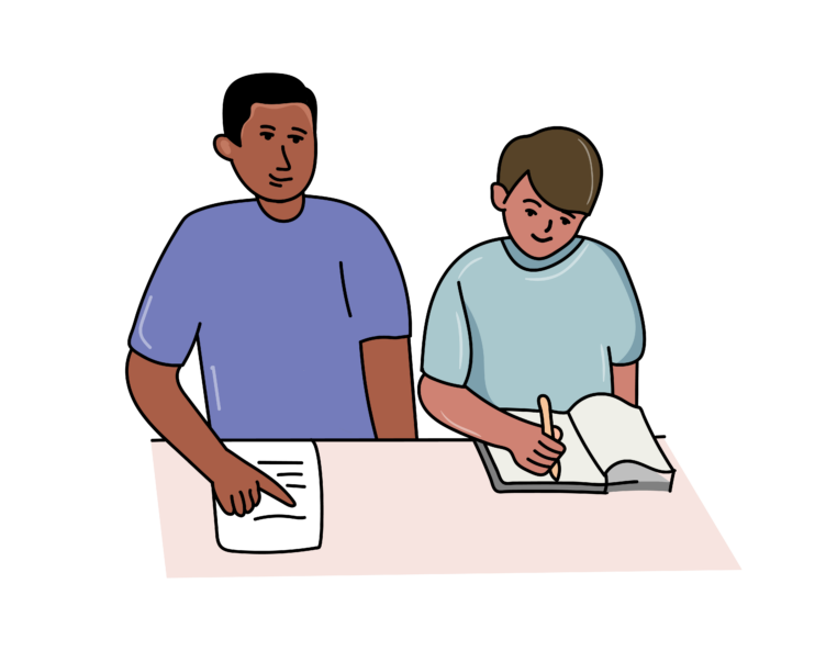 Two children sat at a desk reading.