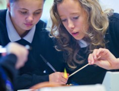 Pupils lighting a Bunsen burner using a wooden spill