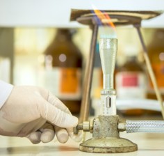 Turning on the gas on a Bunsen burner